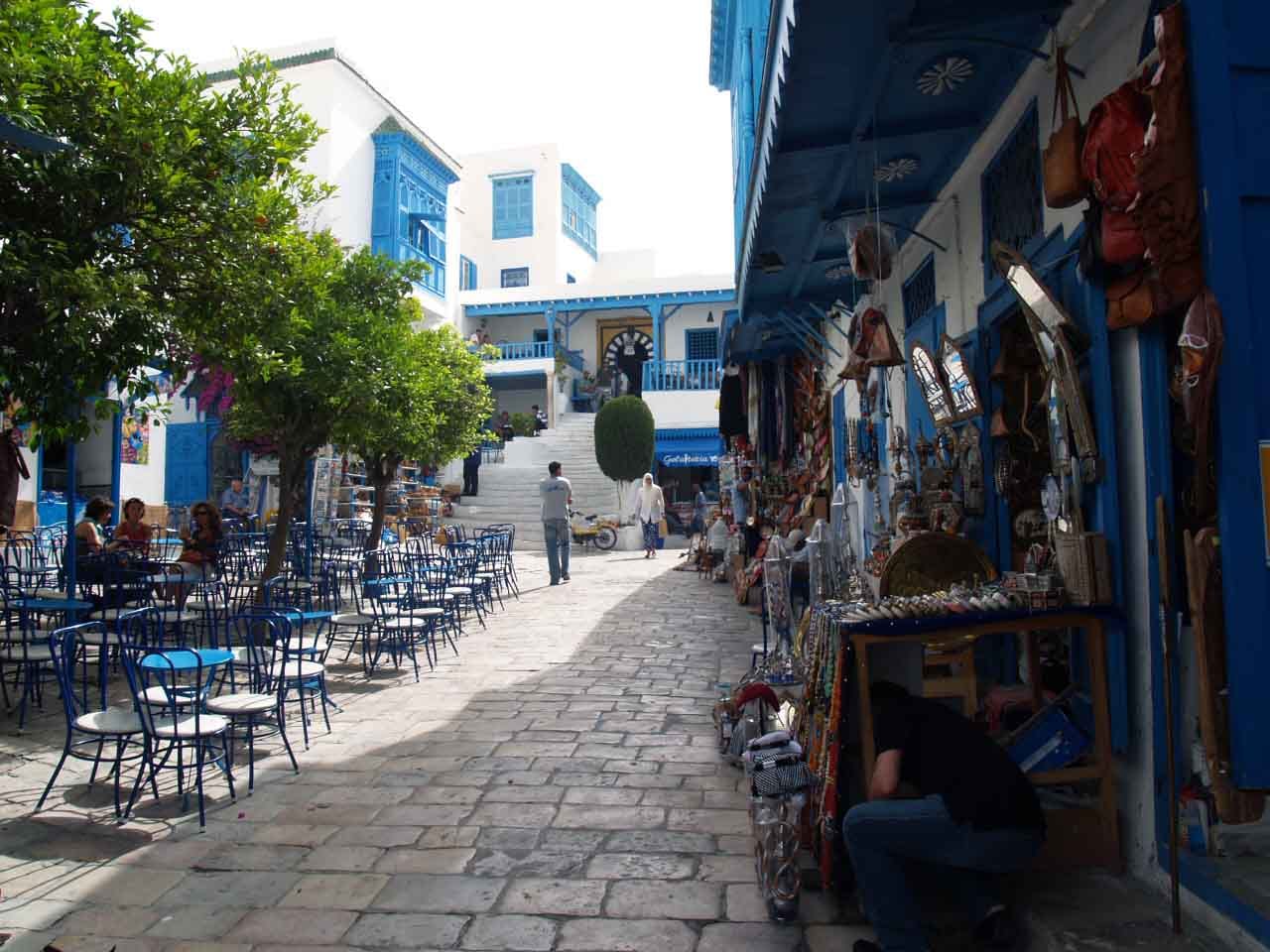 The main square of Sidi Bou Said with blue café chairs under the trees