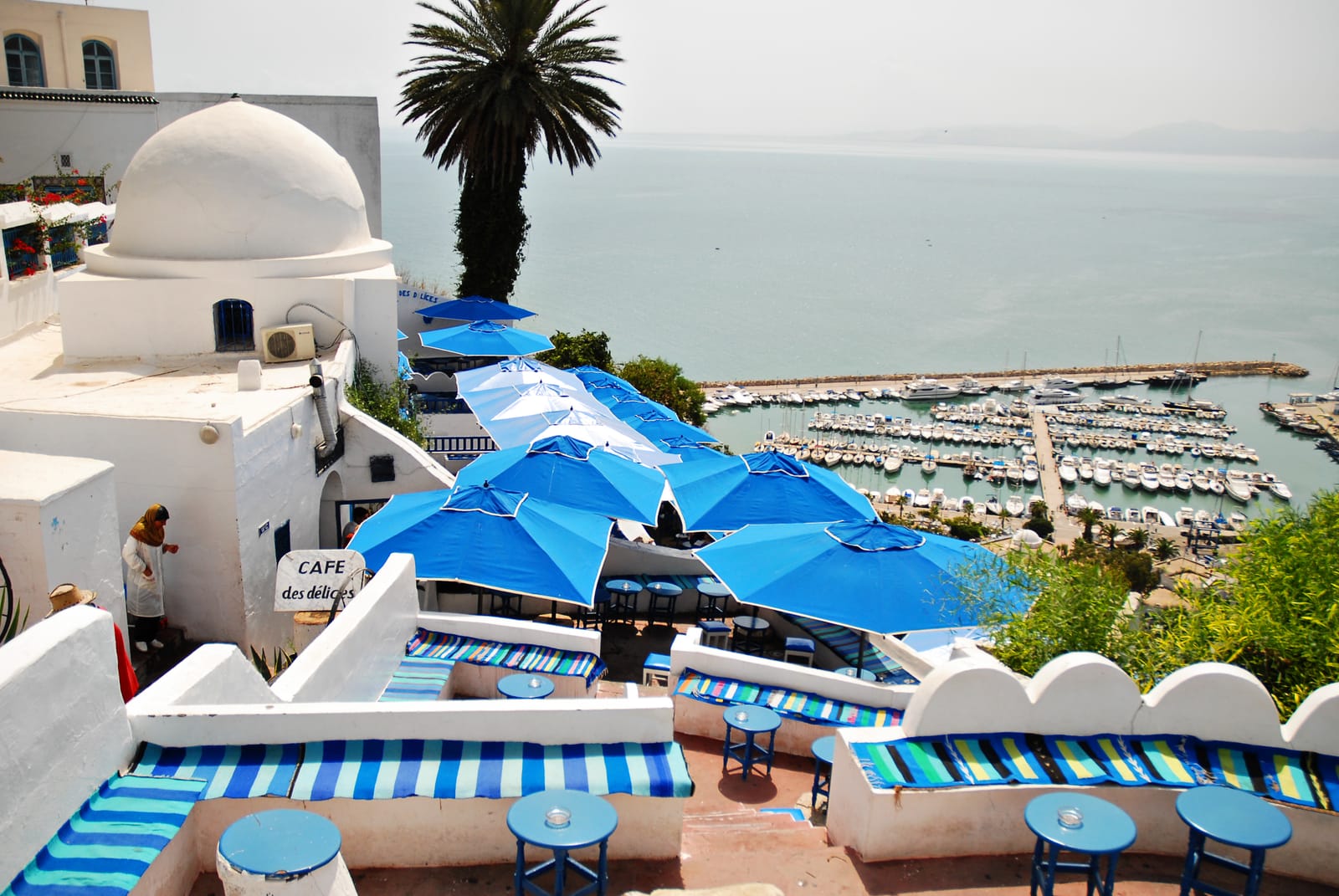 Blue parasols on a café terrace looking down over Sidi Bou Said marina